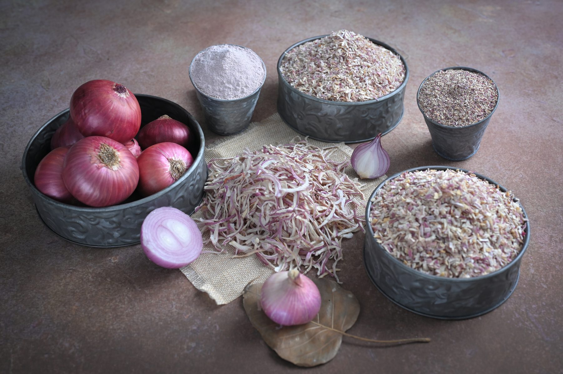 Pink onions with dehydrated onion flakes, powder, and granules